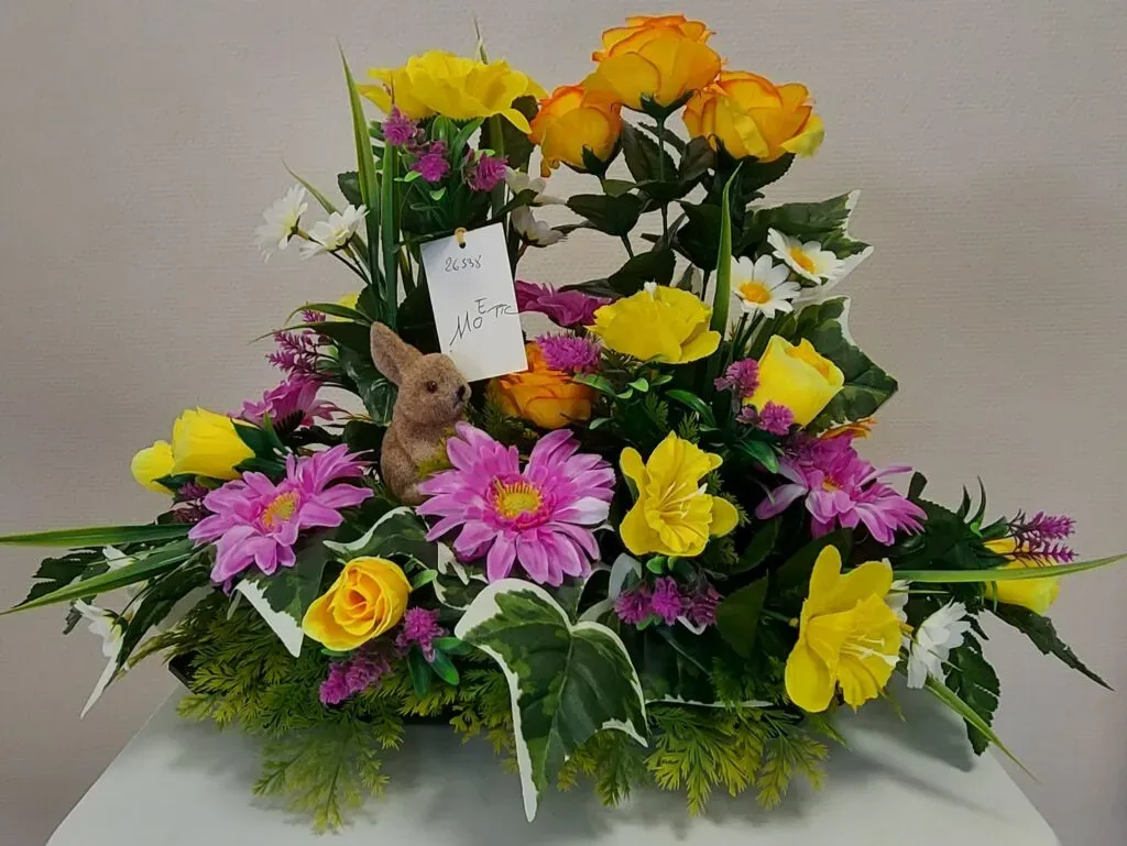 Composition florale funéraire de printemps avec petit lapin.